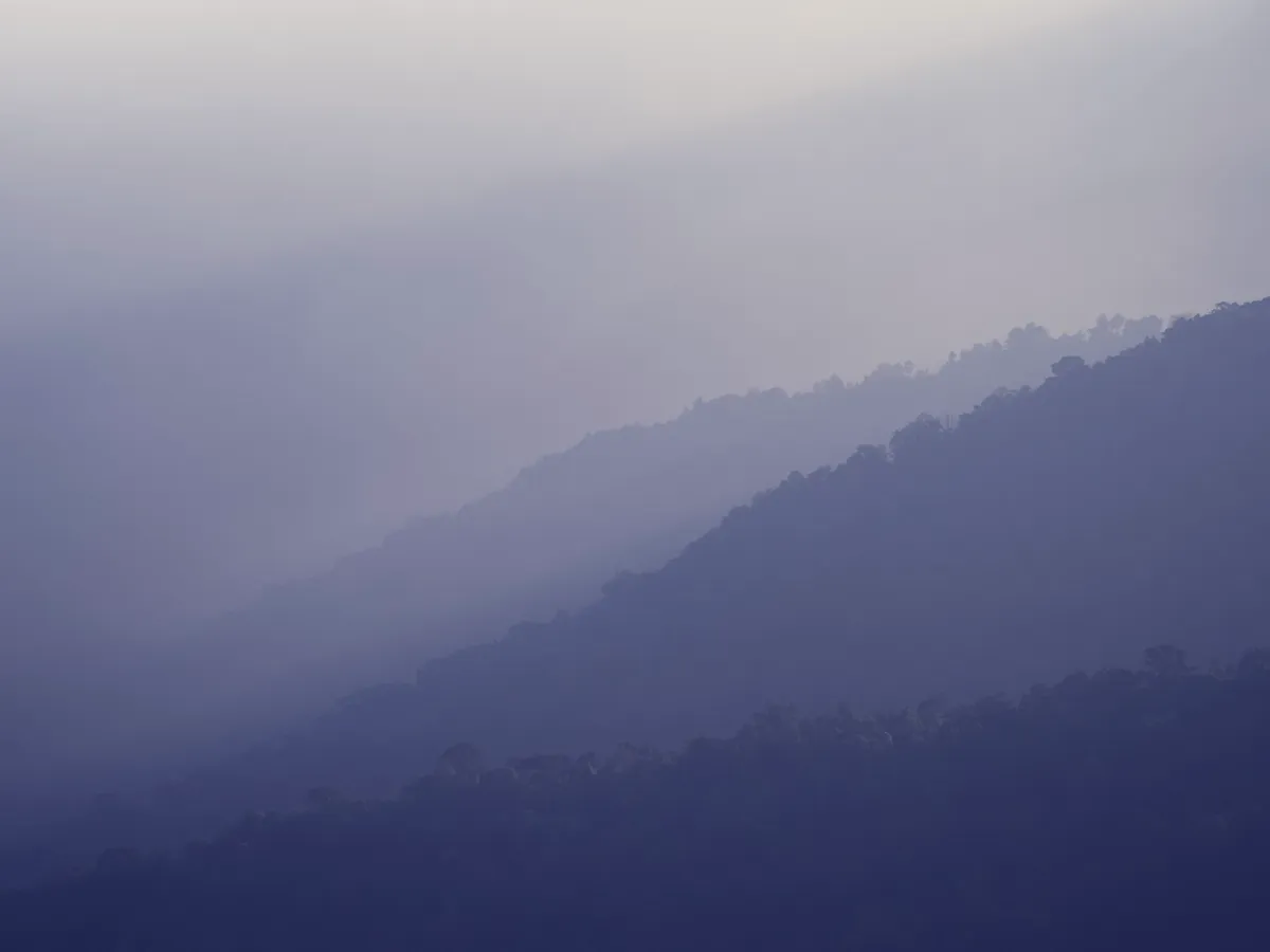Layered blue mountain ridges fading into haze below the Clingmans Dome observation tower
